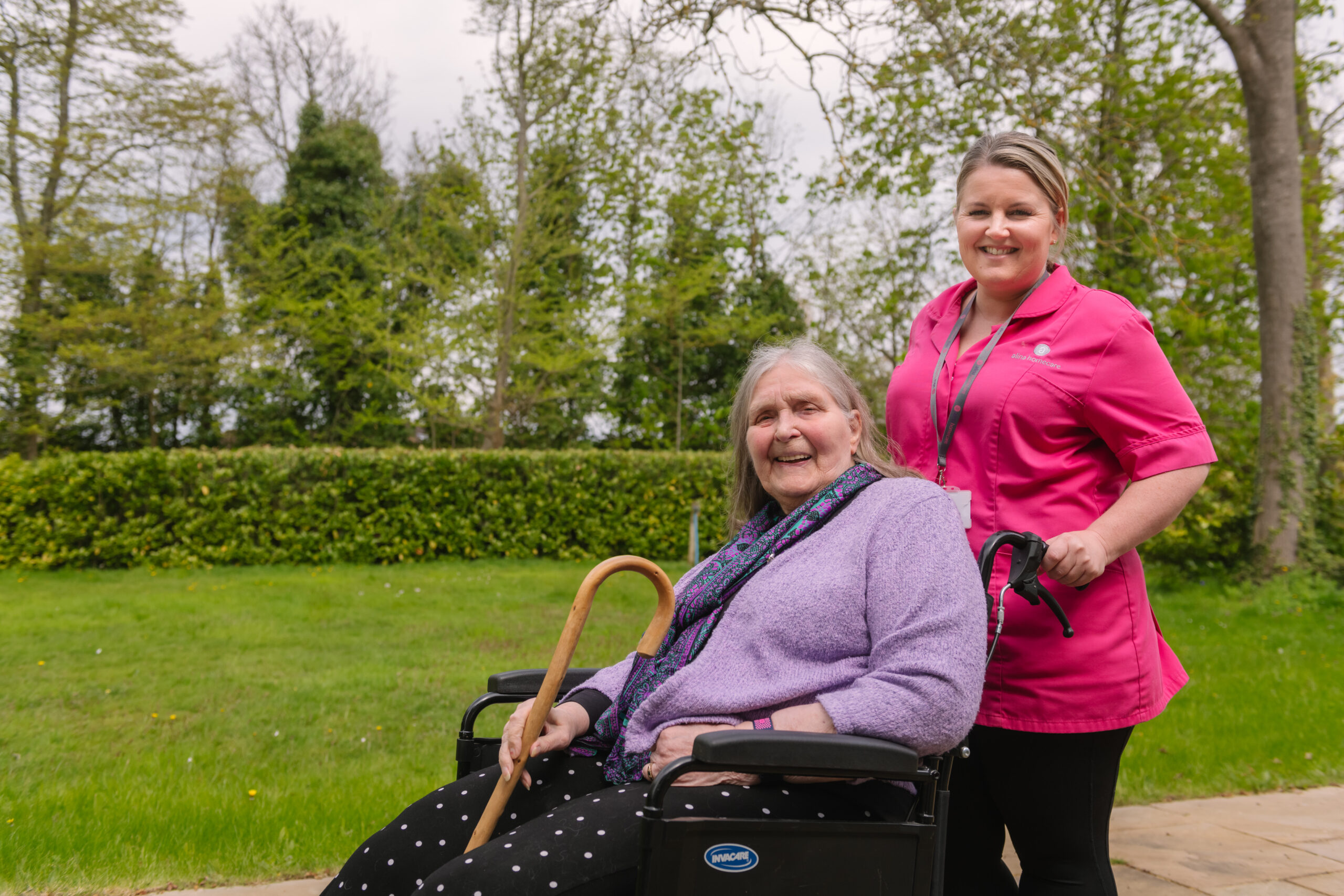 Carer assisting elderly client in a wheelchair
